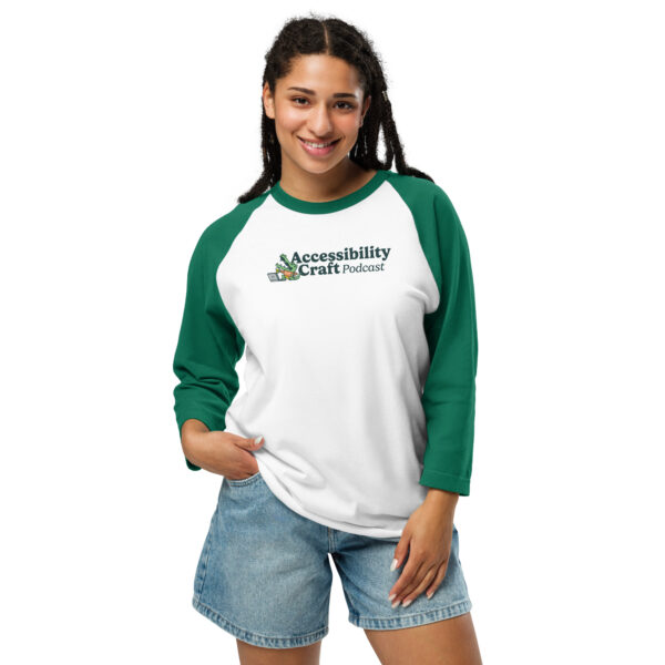 Young woman wearing a Raglan Accessibility craft podcast t-shirt with green sleeves.
