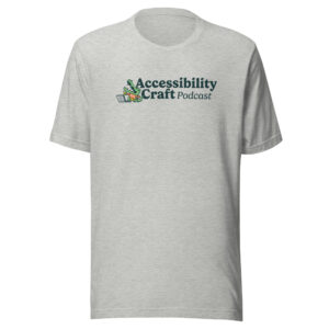 Light gray short-sleeve t-shirt with the Accessibility Craft podcast logo, which includes an alligator wearing a t-shirt with "a11y" on it with a laptop and beer glass.